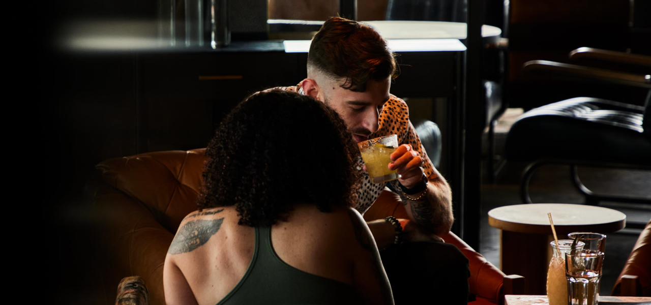 couple having cocktails on a couch