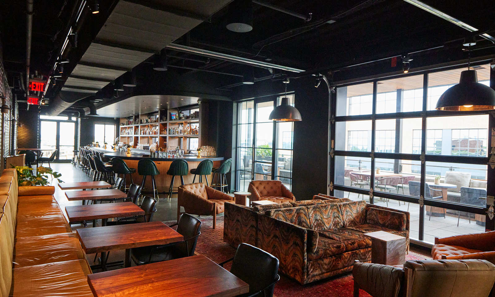 tables and chairs and bar with stools at brass eye