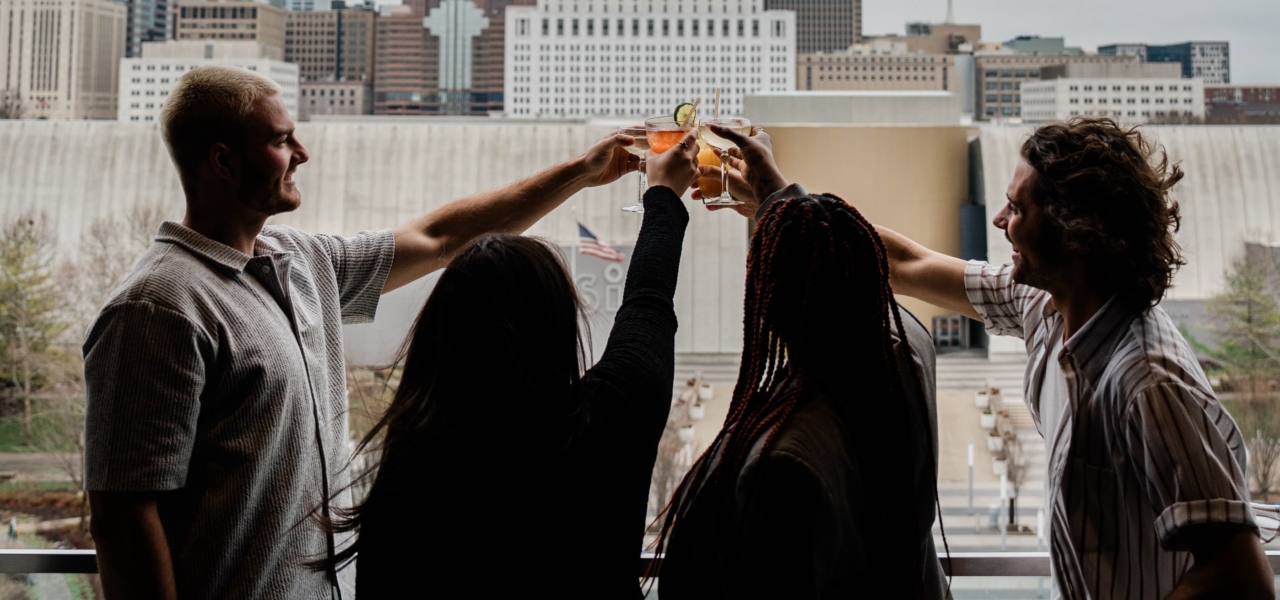 Friends toasting in front of a city skyline