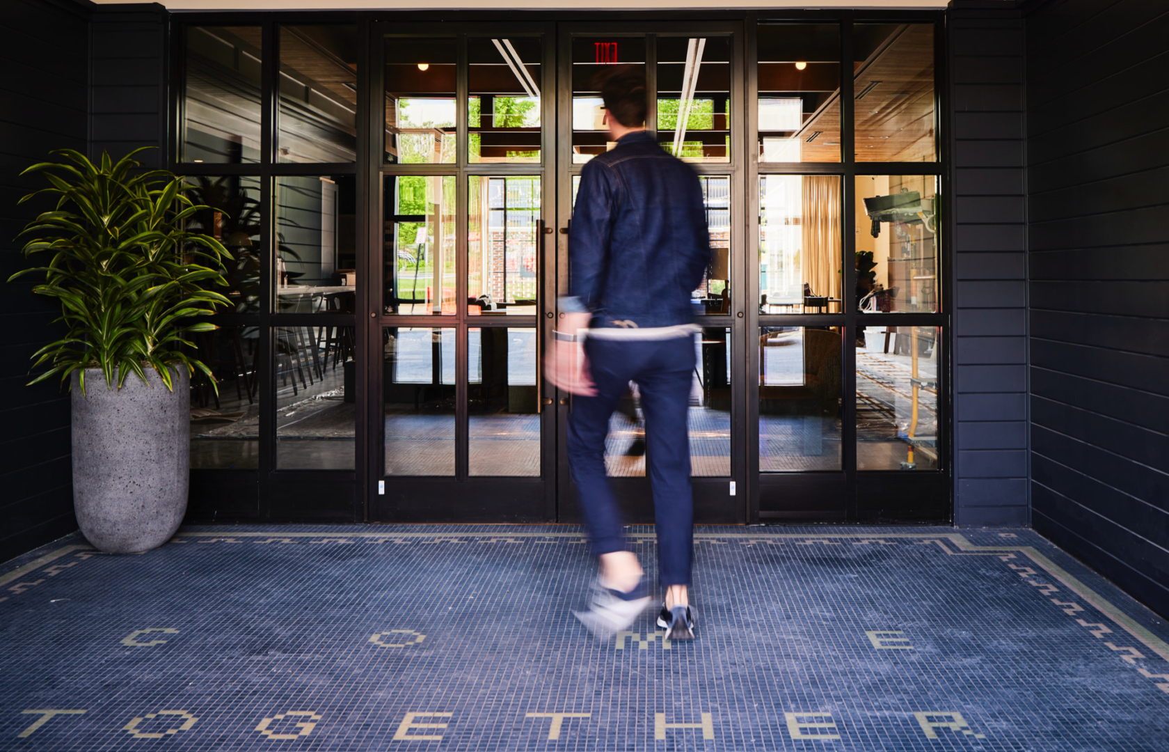 Man entering the Junto Hotel in Columbus, Ohio