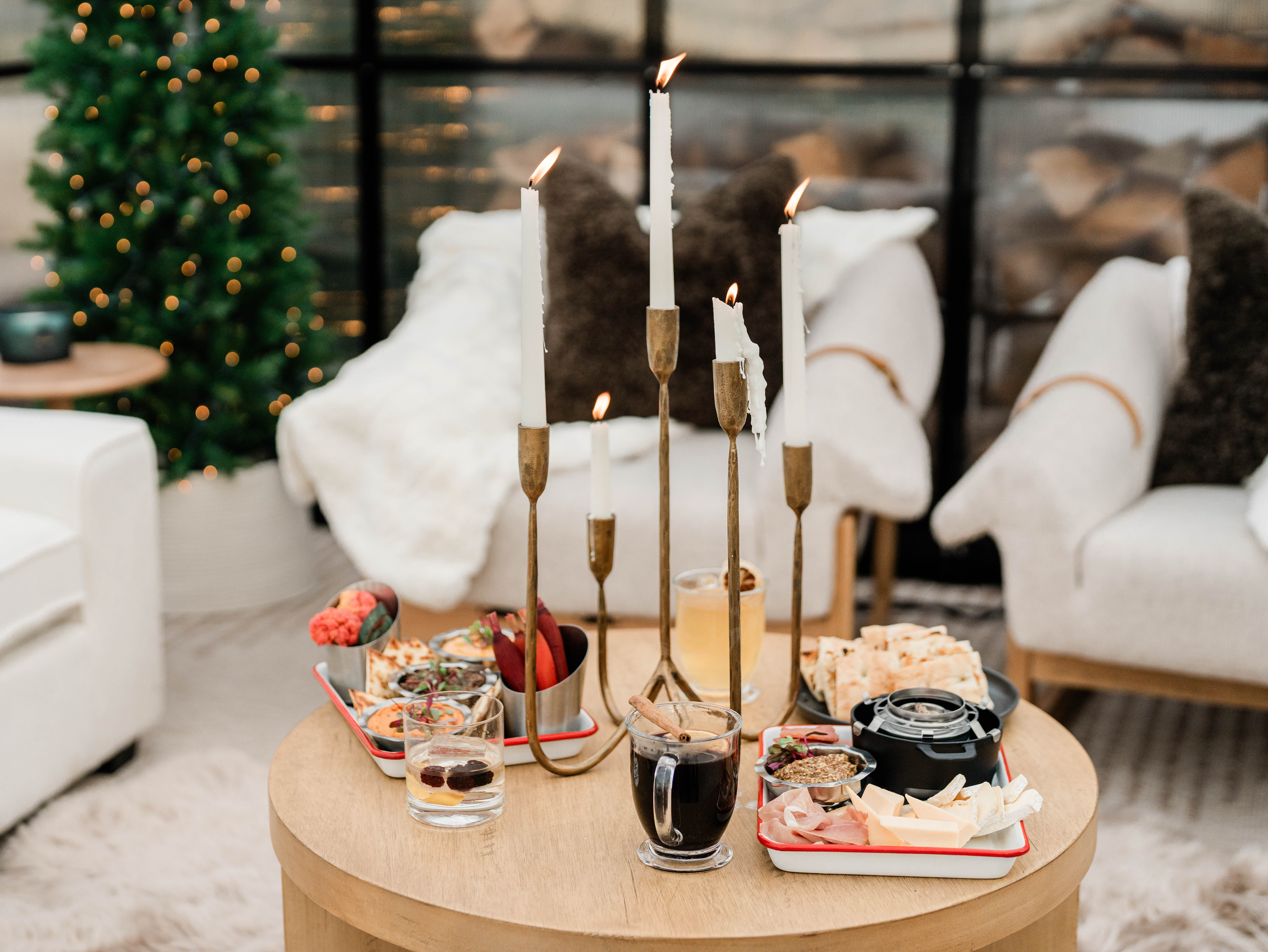 inside of winter greenhouse with cozy furniture and holiday decor