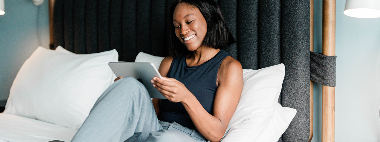 Woman on bed in guest room