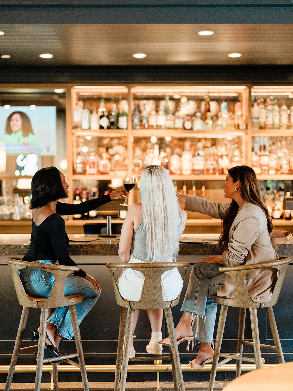 Girls cheersing drinks in Trade Room