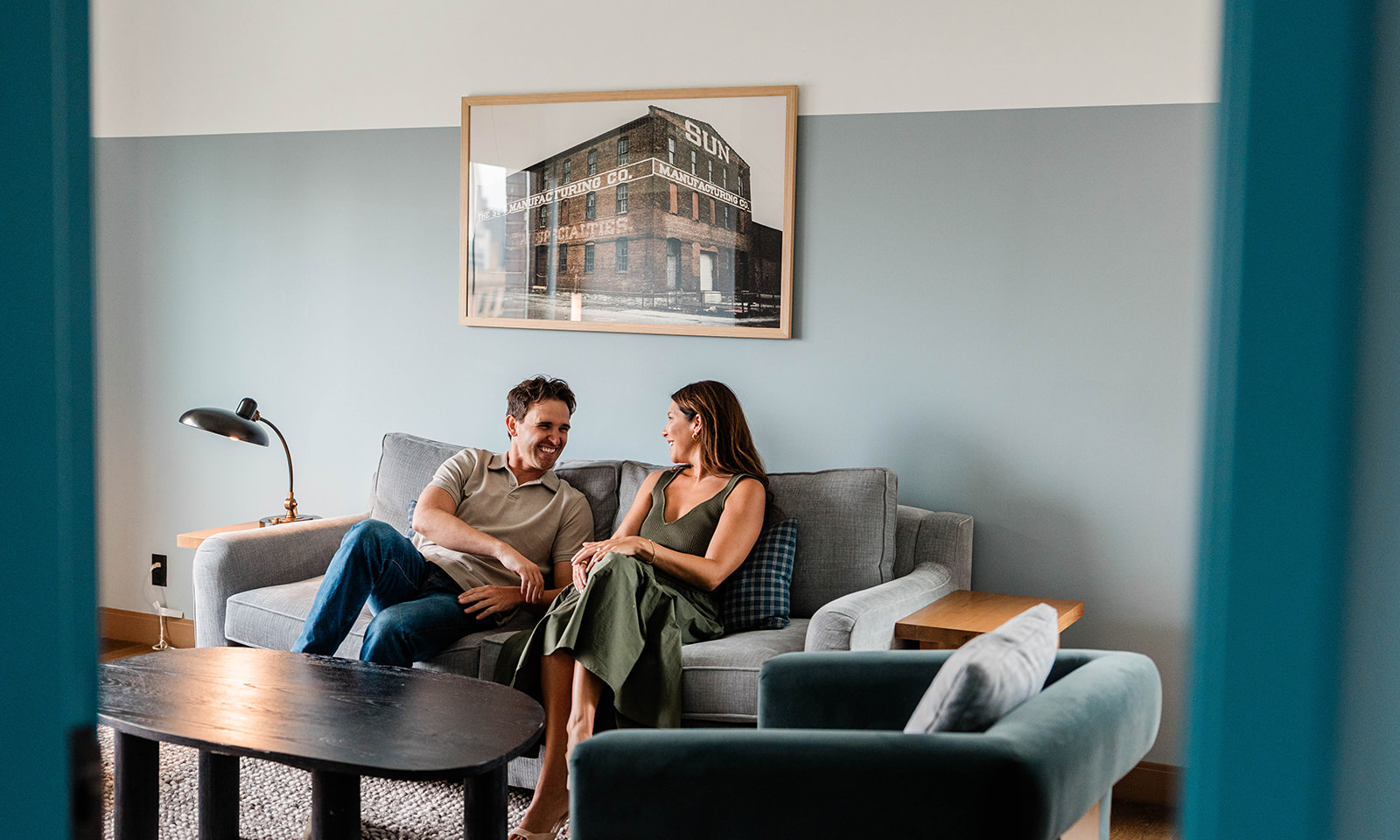 Couple sitting on couch in guest room