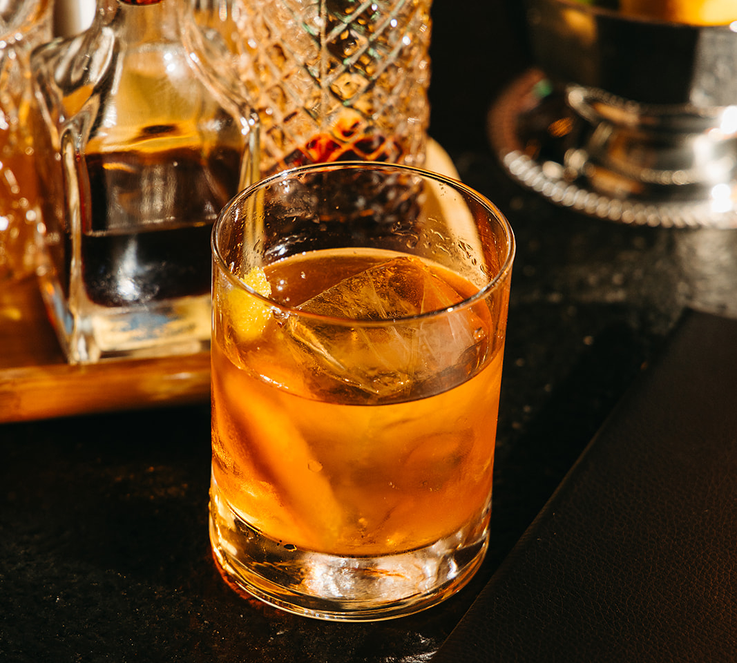 cocktail and menu at brass eye